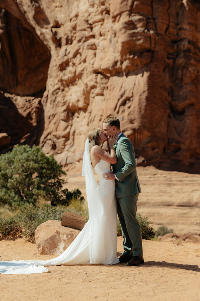 Portrait of the bridegroom, kissing after their wedding ceremony