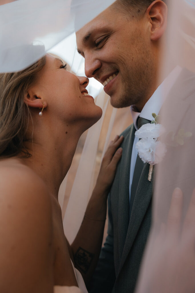 Portrait of the bride and groom, smiling at each other