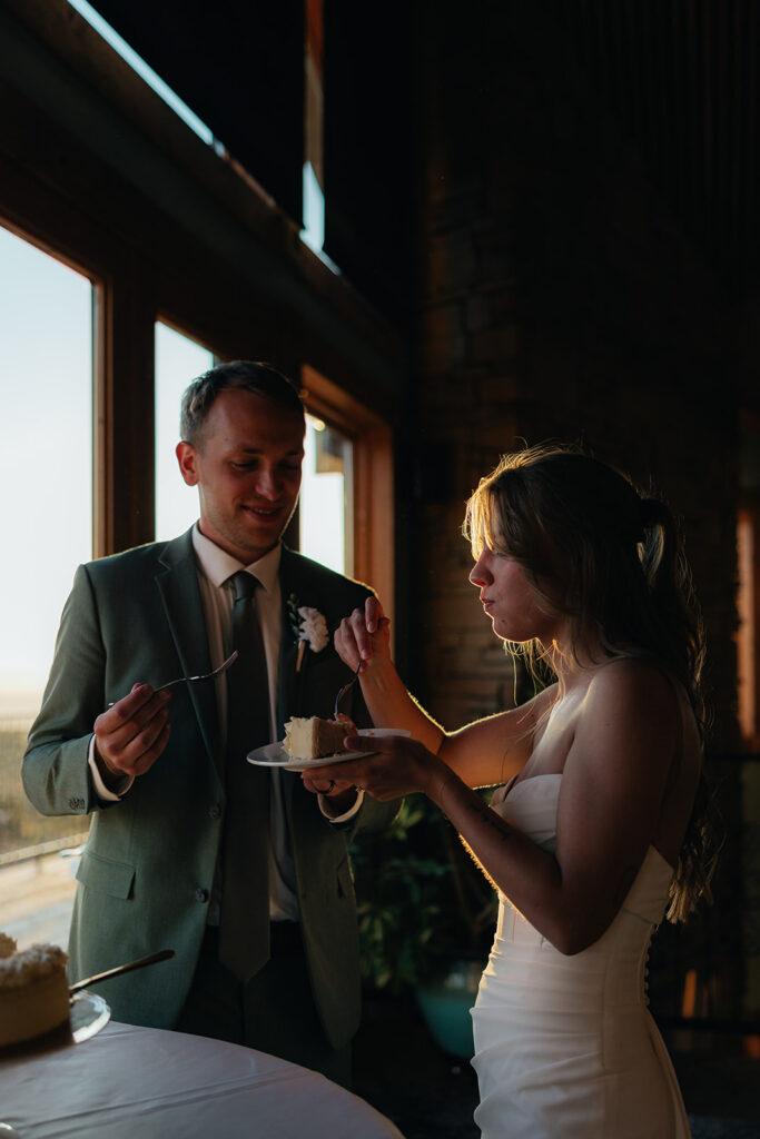 Newly married couple trying their wedding cake