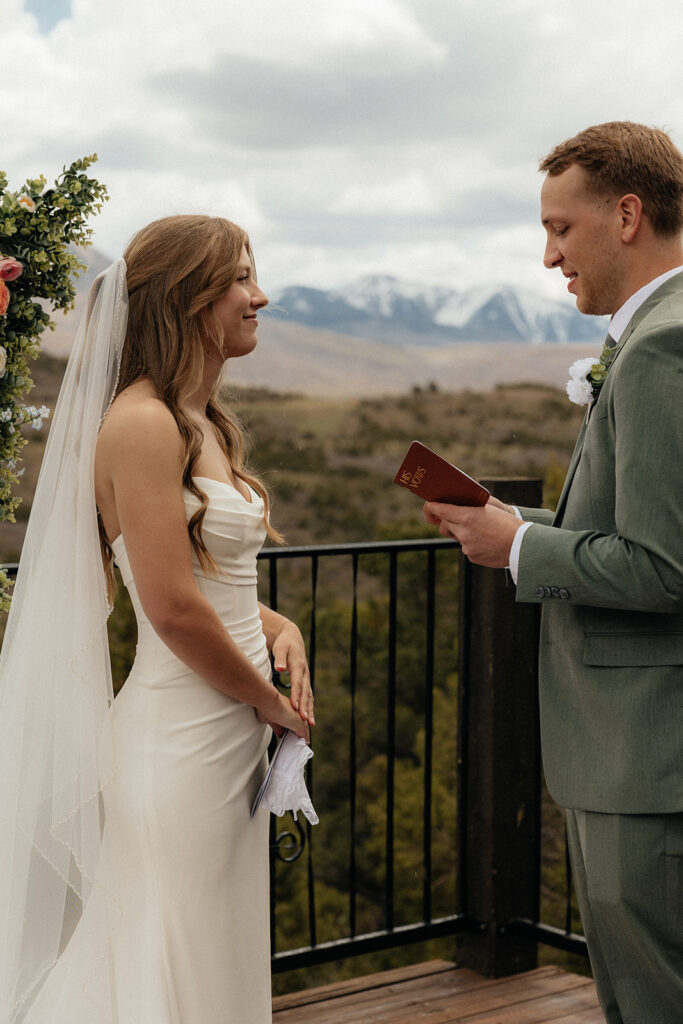Portrait of the bride and groom reading their vows