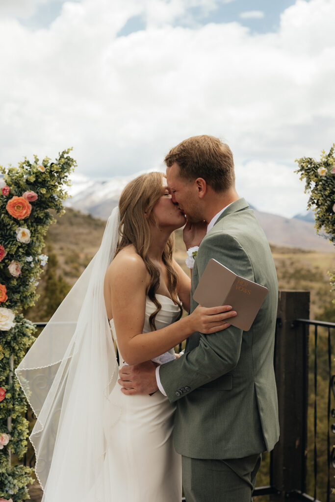 Bride and groom, kissing before their certainly