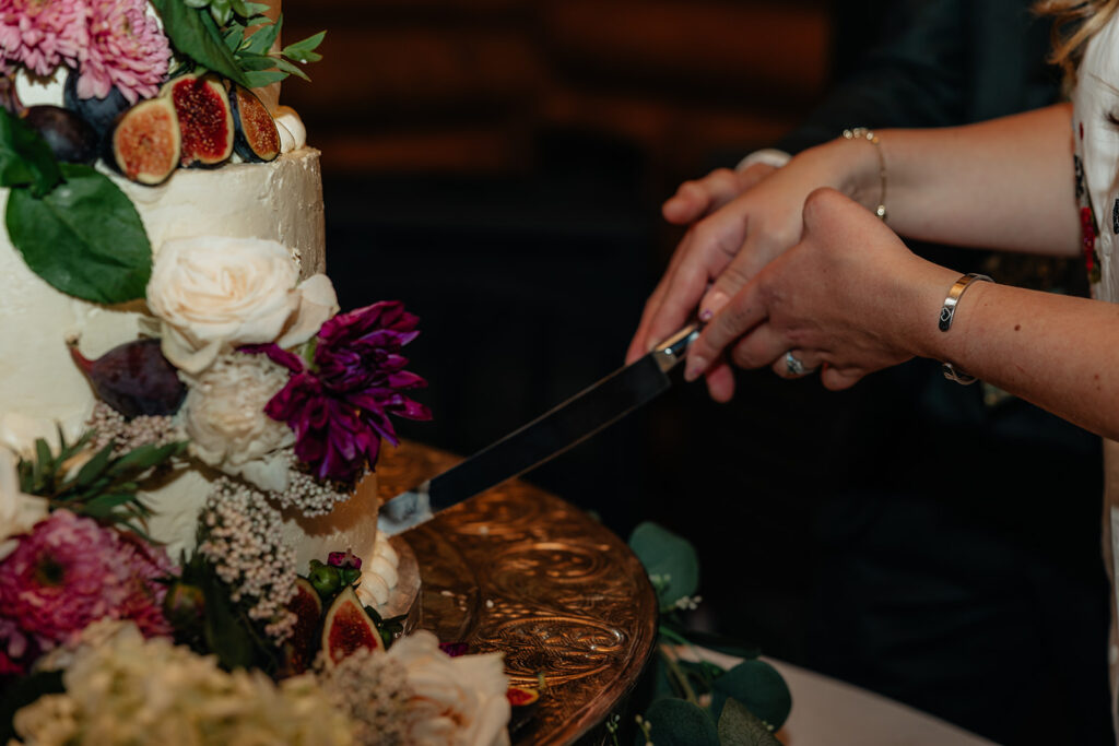newlyweds cutting their wedding cake
