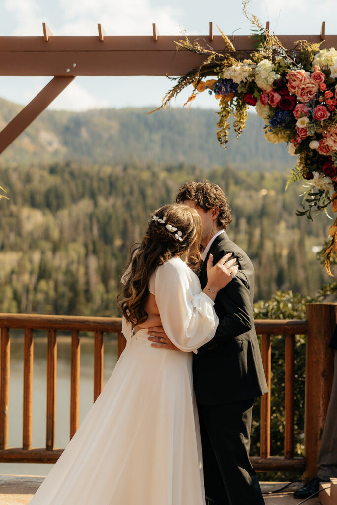 cute picture of the bride and groom kissing after their ceremony
