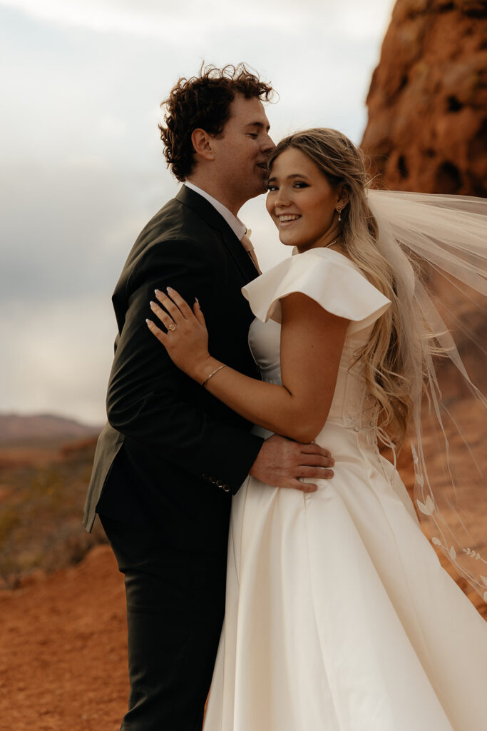 groom kissing the bride on the forehead