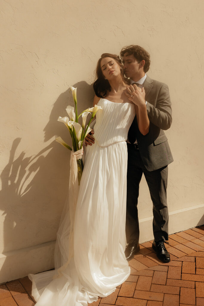 groom kissing the bride on the cheek