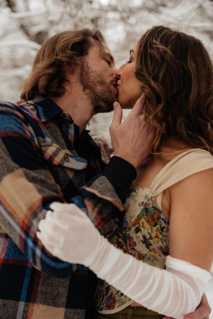 cute portrait of the newly engaged couple kissing