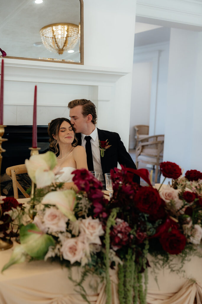 groom kissing the bride on the forehead