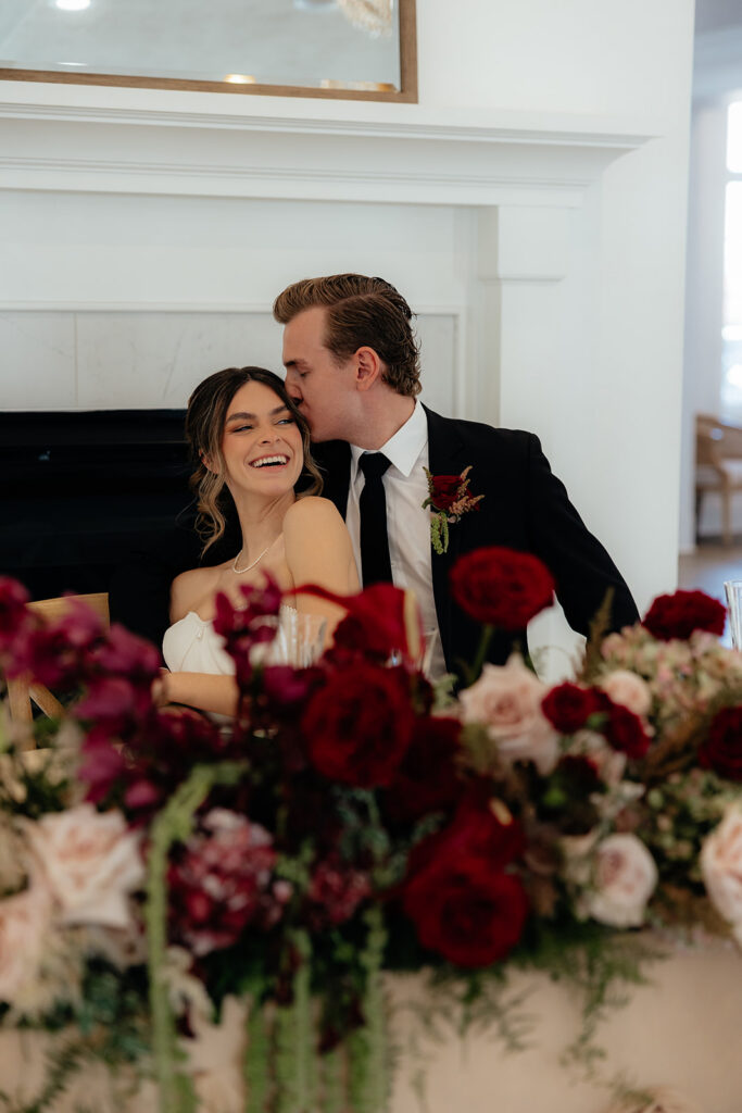 groom kissing the bride on the cheek