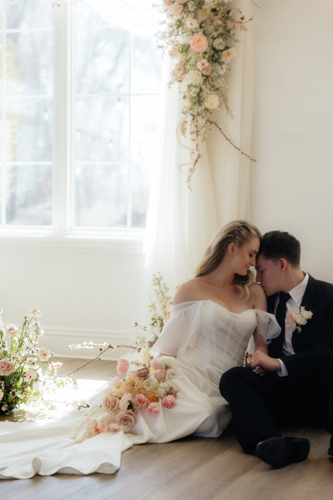 groom kissing the bride on the shoulder