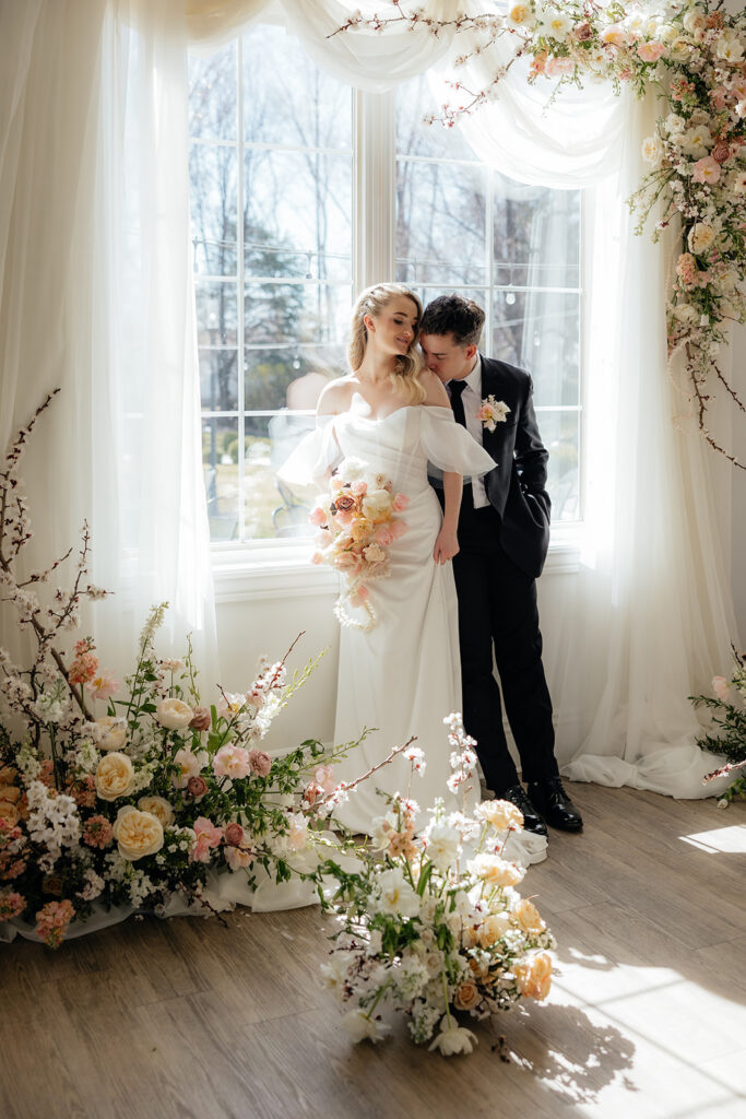 cute picture of the groom kissing the bride on the cheek