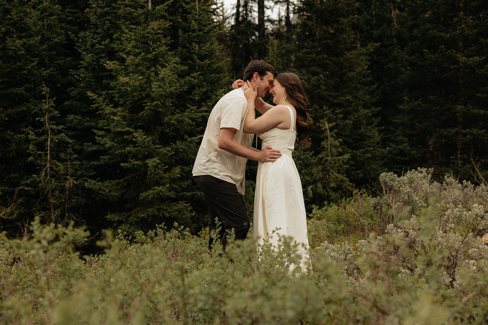 fiance kissing his fiance on the forehead