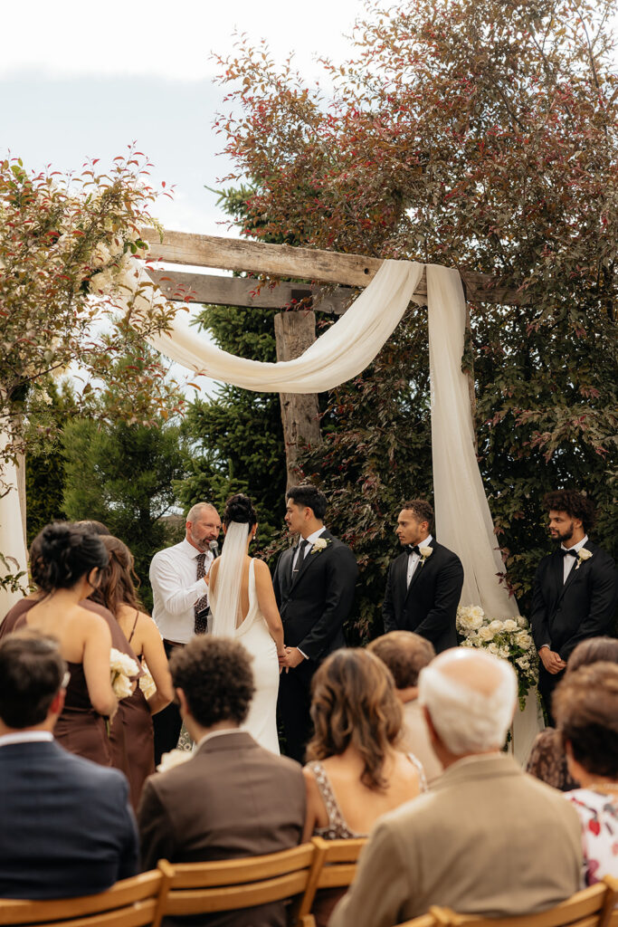 bride and groom holding hands during their wedding ceremony