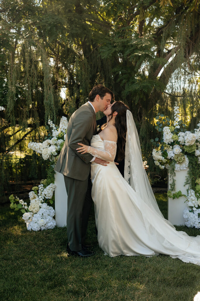 newlyweds kissing after their wedding ceremony